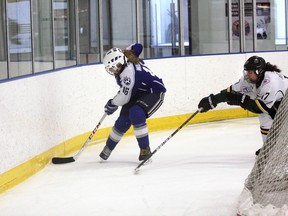 Sydney Walker of the Sudbury Lady Wolves midget AA gets to a loose puck ahead of a Stoney Creek defender during the OWHA provincial championship final game at Buckingham Arena in Stoney Creek on Sunday afternoon.