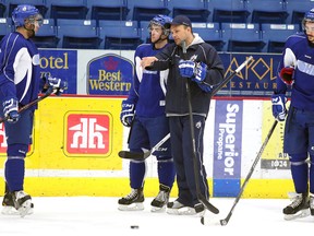 Sudbury Wolves head coach Paul Fixter talks with Mathew Campagna as Nick Baptiste and Trevor Carrick look on during team practice at Sudbury Community Arena on March 24.