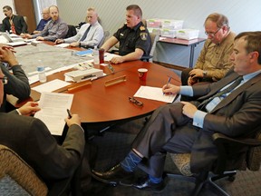 Fire Chief Mark MacDonald, top centre, speaks to public officials including Mayor Neil Ellis, right, during an emergency meeting about flooding in Belleville Monday. The city's state of emergency is to remain in effect for at least a week. 
Luke Hendry/The Intelligencer