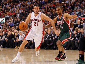Toronto Raptors guard Greivis Vasquez  carries the ball past Milwaukee Bucks guard Ramon Sessions (13) during the first half at the Air Canada Centre on April 14. (John E. Sokolowski-USA TODAY Sports)