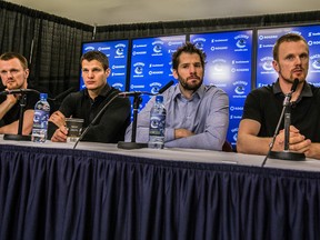Vancouver Canucks (from left) Henrik Sedin, Kevin Bieksa, Ryan Kesler and Daniel Sedin answer questions during an end of season news conference in Vancouver Monday April 14, 2014. (CARMINE MARINELLI/QMI Agency)