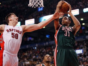Raptors’ Tyler Hansbrough (left) tries to get in the way of Milwaukee Bucks’ John Henson on Monday night at the Air Canada Centre. (USA TODAY SPORTS/PHOTO)