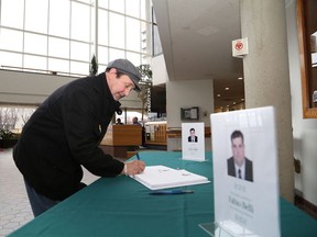 JOHN LAPPA/THE SUDBURY STAR/QMI AGENCY 
Vincent Lacroix signs a book of condolences on Monday  Tom Davies Square for Ward 8 Coun. Fabio Belli, who passed away on Saturday. The book will be available for signing in the main foyer at city hall until April 22 and then the book will be given to the Belli family.