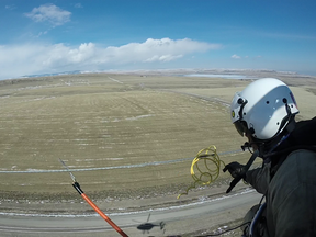 Get to the ‘Choppa!’ AltaLink crews took to the skies above Pincher Creek to install 240 bird diverters in an effort to reduce avian deaths in the area. The orange stick seen below is used to ensure the crew and helicopter are at the same potential as the overhead shield wire. Without the bonding wand crew members would be shocked upon touching the overhead wire. Photos submitted.