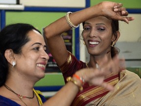 Indian transgender residents dance with others at an event to celebrate a Supreme Court judgement in Mumbai on April 15, 2014. (AFP PHOTO/PUNIT PARANJPE)