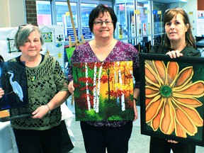 Pictured above is Linda Rupp, Jane Thuss and MaryAnne LeGras-Nikkel holding their favorite pieces of work, 25% of their sales were donated to the Foundation.