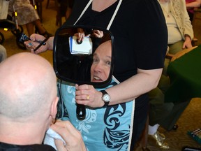 Chef James Rowley gives a look of surprise as he catches a glimpse of himself sans facial hair for the first time in 20 years. John Stoesser/QMI Agency