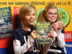 Tommy and Melanie Glatzmayer show off their book "Tommy and Melanie have two rats and one syndrome" during a presentation earlier this year. They will be speaking Wednesday at Queen's University.