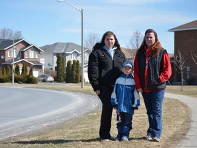 Jazmin Harper (left) with her son, Seth, and mother Khrys Beatty. Jazmin said she is concerned for her family and her dog. She doesn't understand why rats have taken over such a nice neighbourhood. 
Michelle Ferguson/For the Whig-Standard
