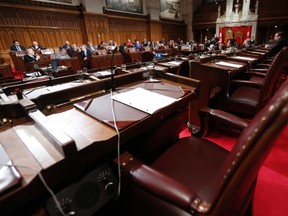 Suspended Senator Mike Duffy's seat is seen empty during a royal assent ceremony in the Senate chamber on Parliament Hill in Ottawa December 12, 2013. (REUTERS/Chris Wattie)