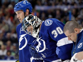 Tampa Bay Lightning goalie Ben Bishop is helped off the ice after suffering an upper-body injury against the Toronto Maple Leafs at Tampa Bay Times Forum. (Kim Klement/USA TODAY Sports)