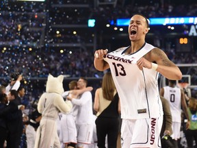 Connecticut Huskies guard Shabazz Napier (13) celebrate after defeating the Kentucky Wildcats 60-54 in the championship game of the Final Four in the 2014 NCAA Mens Division I Championship tournament at AT&T Stadium on Apr 7, 2014 in Arlington, TX, USA. (Bob Donnan/USA TODAY Sports)