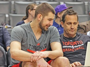Jonas Valanciunas works with assistant coach Bill Bayno ahead of a game earlier this month. (STAN BEHAL/Toronto Sun)