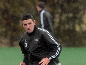 Ottawa Fury's Andres Fresenga warms up in the rain at practice at Carleton University Tuesday.  Tony Caldwell/Ottawa Sun