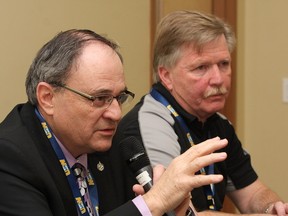 JOHN LAPPA/THE SUDBURY STAR/QMI AGENCY 
NIckel Belt MP Claude Gravelle, left, makes a point as Stephen Hunt, director of USW District 3, looks on during a panel discussion at the first day of a forum commemorating the 1974 Elliot Lake Miners' Strike at the Steelworkers Hall in Sudbury, ON. on Tuesday, April 15, 2014.