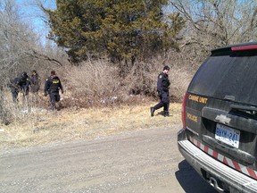 Members of the OPP conduct a search in a wooded area on Cannery Road in Tyendinaga, Ont., Wednesday morning, April 16, 2014. - JEROME LESSARD/THE INTELLIGENCER/QMI AGENCY