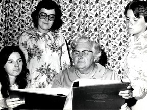 Tweedsmuir history books were explained by curator Maxine Davis during a May, 1971 meeting of Yarmouth Glen Women's Institute. Looking over the Tweedsmuir book with Mrs. Davis are, from left, Colleen Berry, Barbara Knowles, Brenda Bechard. 
St. Thomas Times-Journal Collection/Elgin County Archives