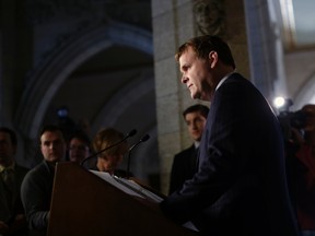 Canada's Foreign Minister John Baird listens to a question while speaking about the situation in the Ukraine during a news conference on Parliament Hill in Ottawa March 13, 2014. (REUTERS/Chris Wattie)