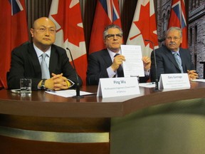 Ping Wu, president of the Professional Engineers Government of Ontario (PEGO), Gary Gannage, president of AMAPCEO, and Warren "Smokey" Thomas, president of the Ontario Public Service Employees Union (OPSEU) sign pact to support each other through negotiations with Ontario government on April 16, 2014. (Antonella Artuso/Toronto Sun)