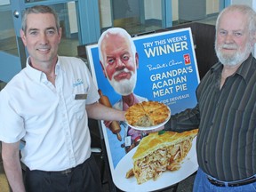 Lambton College hosted a meet and greet with Alcide Desveaux, second place winner on CBC TV's Recipe to Riches show, on Wednesday, April 16, 2014. His signature Acadian meat pie was served for lunch at the college cafeteria, where his son Dave is the daytime chef with Chartwells, the college's campus food service company. Father and son hold one of the meat pies in front of a serving station and sign promoting the pies. (DAVID PATTENAUDE, QMI Agency)