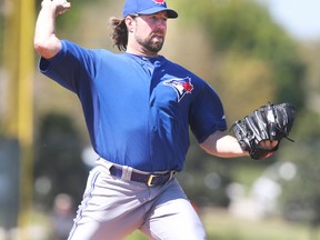 Blue Jays pitcher R.A. Dickey will have to battle the elements on the afternoon of Thurs. April 17, 2014, when the Jays and Twins try to play a split doubleheader.  (VERONICA HENRI/Toronto Sun)