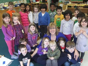 Melissa Coy sits surrounded by some of the children attending her Bayside Montessori School on Woodbine Drive.
Michael Lea The Whig-Standard