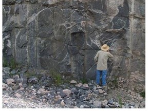 Geochronologist Dr. Tom Krogh examining a rock face.  
Jason Krogh