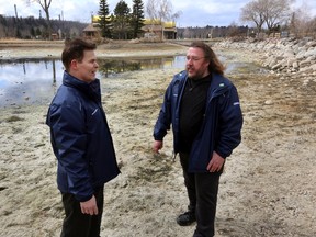 James Wilke, Director of Animal Care and Pest Management chats with Mike Jenkins, Biological Sciences Technician during a news conference on mosquitoes season at Rundle Park in Edmonton, Alberta on Monday, April 16, 2014.    Perry Mah/ Edmonton Sun/ QMI Agency