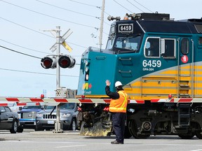 Via employees are stationed at Fallowfield railway crossing due to issues with them working properly as the afternoon train comes in. Sarah Taylor/Ottawa Sun/QMI Agency