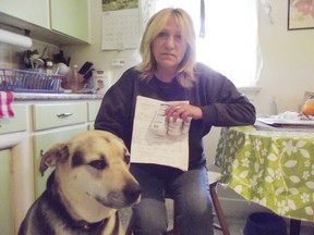 Jim Moodie/The Sudbury Star
Heather Zeffer, with dog Hooch, holds medication she purchased to help treat a german shepherd she is accused of stealing from the home of a Riverside Drive family. Zeffer says she was worried about the dog's health and took him to the vet for assessment.