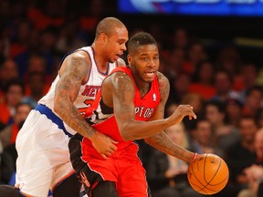 Raptors' Dwight Buycks is fouled by Shannon Brown of the New York Knicks on April 16 (USA Today Sports)