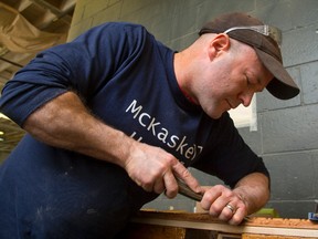 Chris McKaskell runs a woodworking shop that specializes in fine, meticulous hand work, beautiful furniture and hand-carved accents in the style of old world craftsmanship. McKaskell works on a section of hand-carved trim. (MIKE HENSEN, The London Free Press)