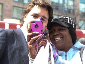 Justin Trudeau gets his picture taken with an unknown person at the State Funeral for Jim Flaherty that took place at  St. James Cathedral on Wednesday, April 16, 2014 in Toronto. (Veronica Henri/QMI Agency)
