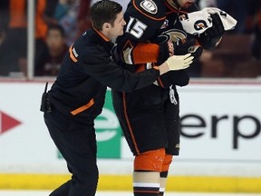 Ducks captain Ryan Getzlaf is attended to by a member of the medical staff after being hit in the face with a puck late in the third period against the Dallas Stars in Anaheim on Wednesday, April 16, 2014. (Jeff Gross/Getty Images/AFP)