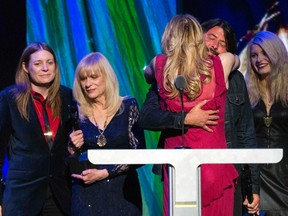 Courtney Love hugs drummer Dave Grohl of Nirvana after the band was inducted during the 29th annual Rock and Roll Hall of Fame Induction Ceremony at the Barclays Center in Brooklyn, New York April 10, 2014.  (REUTERS/Lucas Jackson)