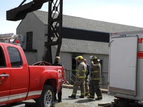 Gananoque firefighters begin to pack up at the scene of last Thursday's fatal fire. William McCafferty, 23, of Gananoque has been charged in connection with the fire, which killed Ian David Wand, 39.