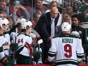 Coach Mike Yeo of the Minnesota Wild talks with Mikko Koivu during a break from the NHL game against the Phoenix Coyotes at Jobing.com Arena on March 29, 2014. (Christian Petersen/Getty Images/AFP)