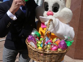 City Councillor Scott McKeen tries out some candy from the Easter Bunny at City Hall in Edmonton, Alberta on Monday, Apr 14, 2014.  Perry Mah/ Edmonton Sun