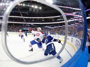 Montreal Canadiens left winger Rene Bourque and Tampa Bay Lightning defenceman Radko Gudas go after the puck during the third period in Game 1 at Tampa Bay Times Forum. (Kim Klement/USA TODAY Sports)