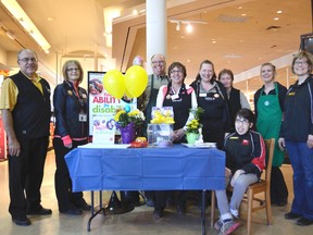 Donna (far right) and Melissa Pickle (sitting), along with Spruce Grove Safeway employees during the Easter Seals campaign kickoff on April 12 in the Grove. - Thomas Miller, Reporter/Examiner