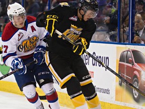 Oil Kings forward Curtis Lazar, shown here battling Brandon's Eric Roy for the puck in the teams’ second-round playoff series, says during extended breaks between series he likes to ‘get away and just be a kid.’ (Codie McLachlan, Edmonton Sun)