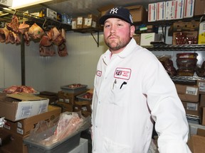 Eric Viau has been a butcher at Saslove's Meat Market for 10 years. The shop operates a large fridge for their meat and is heavily impacted by increasing hydro rates. Sarah Taylor/Ottawa Sun/QMI Agency