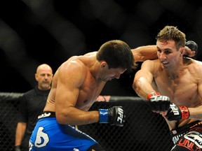 Rory MacDonald (red gloves) throws a punch at Demian Maia during their UFC welterweight bout at Mandalay Bay. (Stephen R. Sylvanie/USA TODAY Sports)