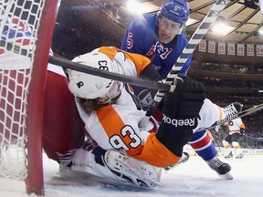 Jakub Voracek of the Philadelphia Flyers is taken down in the crease by Dan Girardi of the New York Rangers during the first period in Game 1 at Madison Square Garden on April 17, 2014. (Bruce Bennett/Getty Images/AFP)