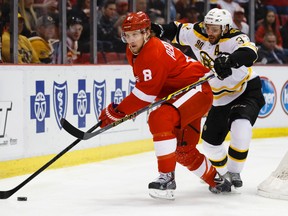 Detroit's Justin Abdelkader tries to elude the checking of Boston's Patrice Bergeron in a regular-season game bwteen the Red Wings and Bruins. The two Original Six franchises battle in Game 1 of the Stanley Cup playoffs on Friday night. (USA TODAY)