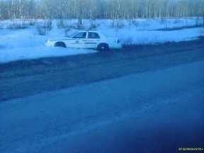A police cruiser in the ditch after a car chase east of Portage la Prairie on Highway 430 near St. Ambroise Thursday night where three people were eventually arrested. (Damon Lavallee/submitted photo)