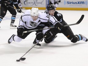 Los Angeles Kings centre Mike Richards (10) and San Jose Sharks defenceman Jason Demers fight for the puck during Game 1 Thursday at SAP Center at San Jose. (Kyle Terada/USA TODAY Sports)