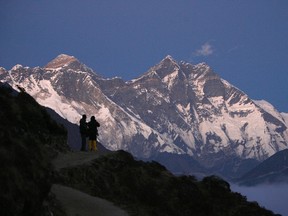 Travellers enjoy a view of Mount Everest at Syangboche in Nepal, in this December 3, 2009 file photograph. An avalanche swept down a slope of Mount Everest on April 18, 2014, killing nine Nepali mountaineering guides at the beginning of the main climbing season, a Tourism Ministry official said. The avalanche hit the most popular route to the mountain's peak and three Nepali guides were injured and some people may be missing, Tilak Ram Pandey, an official at the ministry's mountaineering department, told Reuters.  REUTERS/Gopal Chitrakar/Files