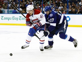 Montreal Canadiens centre Daniel Briere and Tampa Bay Lightning centre Alex Killorn skate for the puck during Game 1 of their Atlantic Division semifinal series at the Tampa Bay Times Forum in Tampa, Fla., April 16, 2014. (KIM KLEMENT/USA Today)