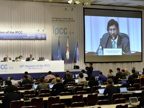 Intergovernmental Panel on Climate Change chairman Rajendra Pachauri speaks. enlarged onscreen, at a press conference after the 10th plenary of the IPCC Working Group II in Yokohamaon March 31. 
YOSHIKAZU TSUNO/AFP